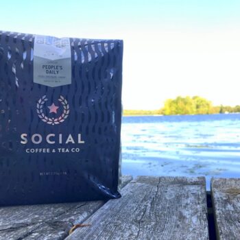 Bag of People's Daily coffee from Social Coffee Company on a dock
