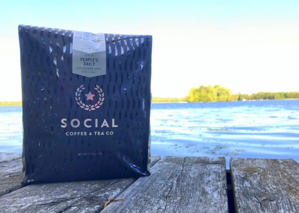 Bag of People's Daily coffee from Social Coffee Company on a dock