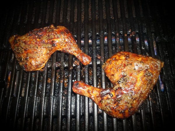 Chicken on a grill which is marinated with Jammin jerk Marinade